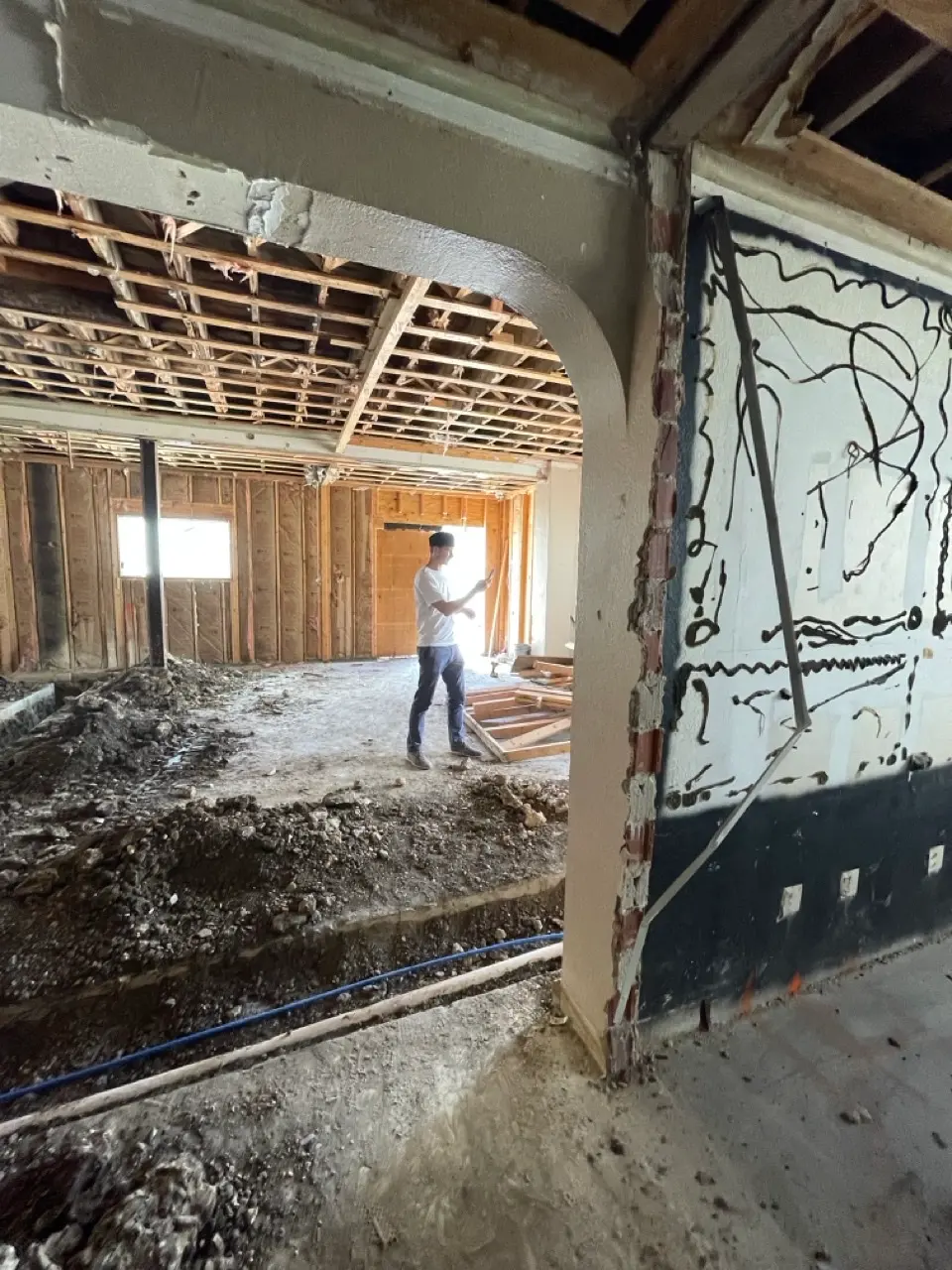 Inside the old studio, stripped back to the studs and the dirt.
