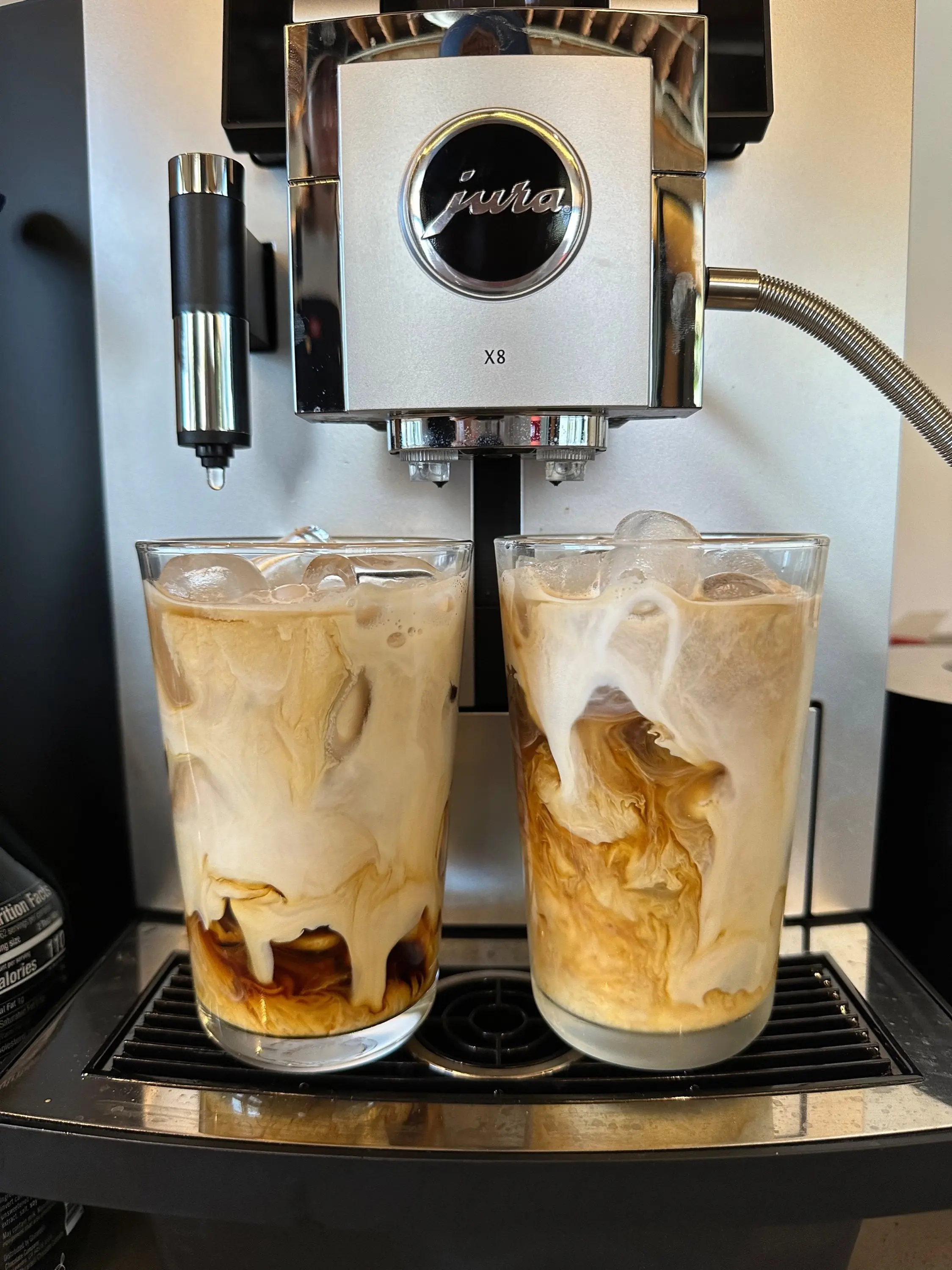 Two iced coffees under the Jura X8 espresso machine
